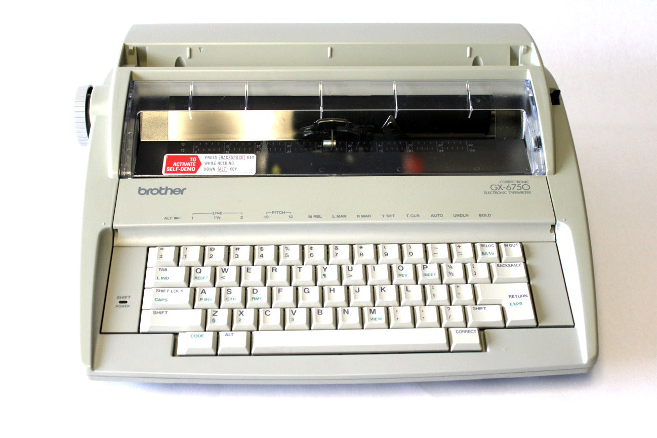 A reconditioned Brother GX-6750 electronic typewriter with the carriage moved to the left side, revealing the typeface.
