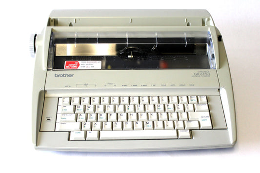 A reconditioned Brother GX-6750 electronic typewriter with the carriage moved to the left side, revealing the typeface.
